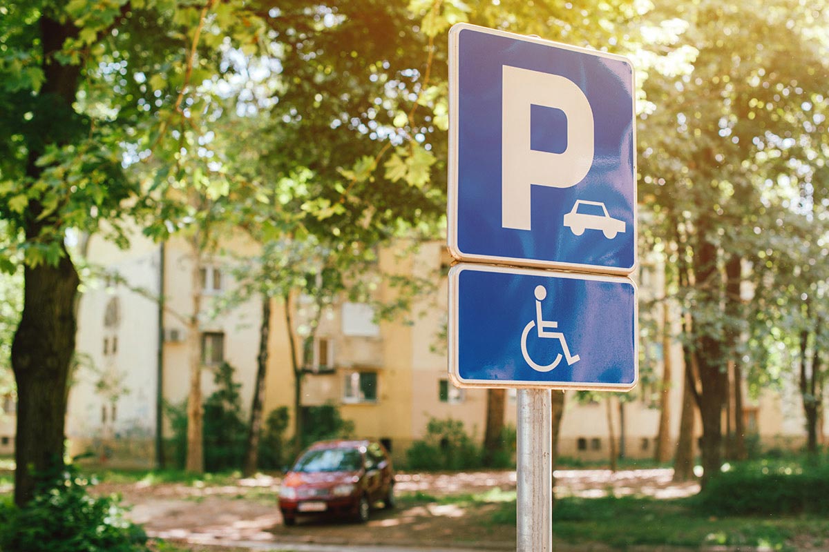 Parking spot sign space for people mobility issues and in favour of universal accessibility